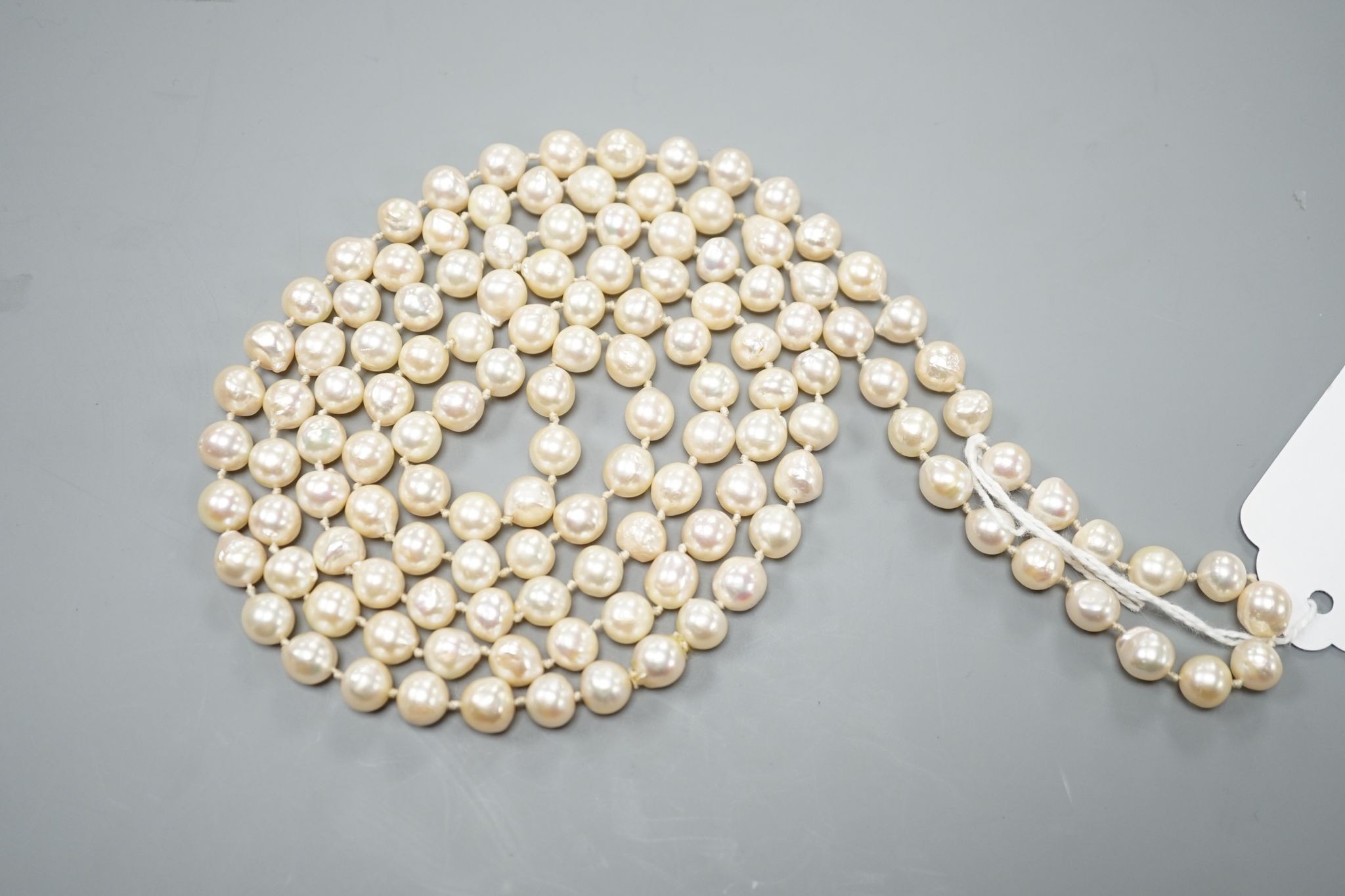 A long single strand baroque cultured pearl necklace, 128cm.
